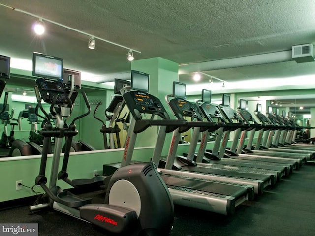 gym featuring a textured ceiling