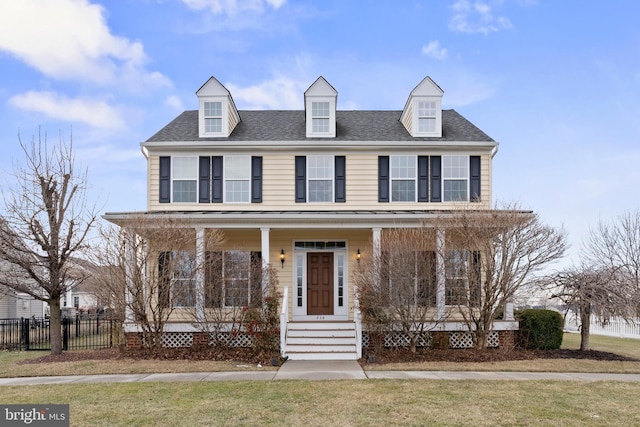 view of front of house with a porch and a front yard