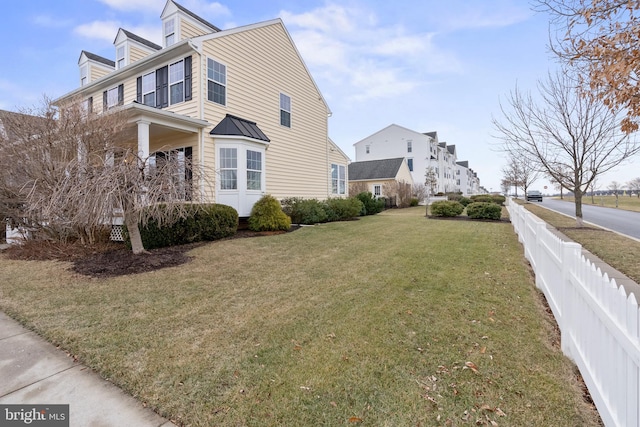 view of side of home with a lawn