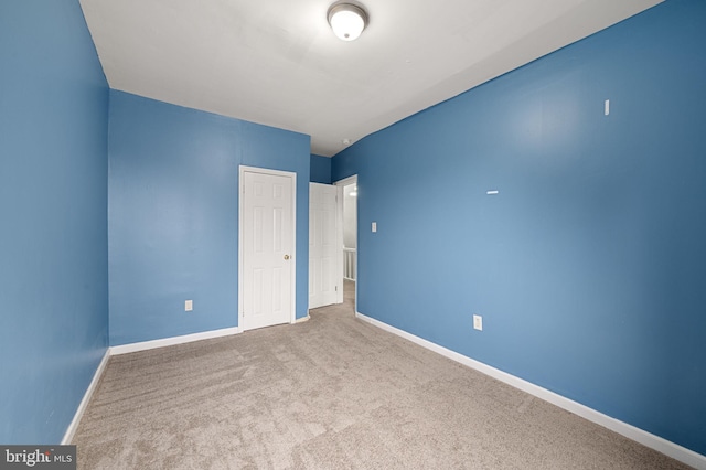 unfurnished bedroom with light carpet