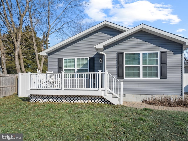 view of front of house with a front yard and a deck