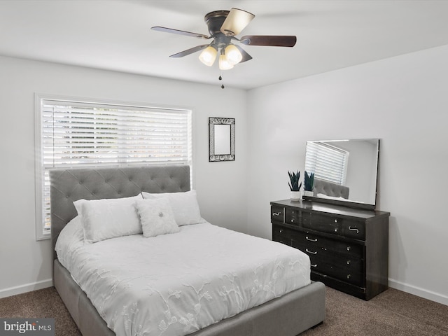 bedroom with dark colored carpet and ceiling fan