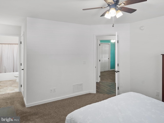 carpeted bedroom featuring ceiling fan and ensuite bathroom