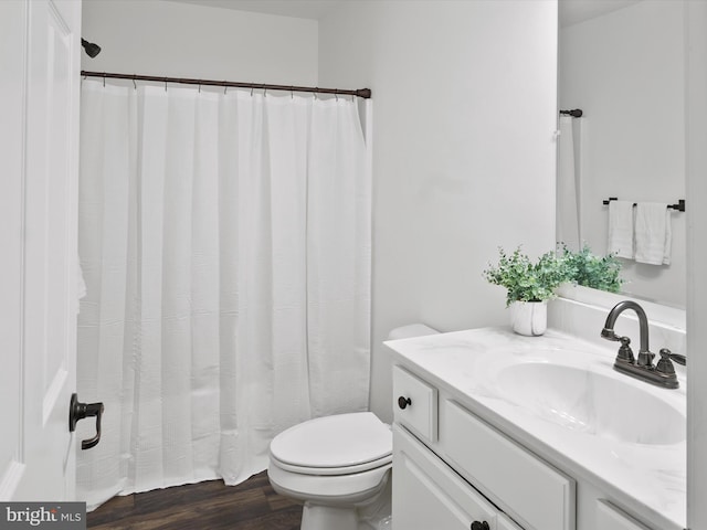 bathroom featuring vanity, hardwood / wood-style flooring, and toilet