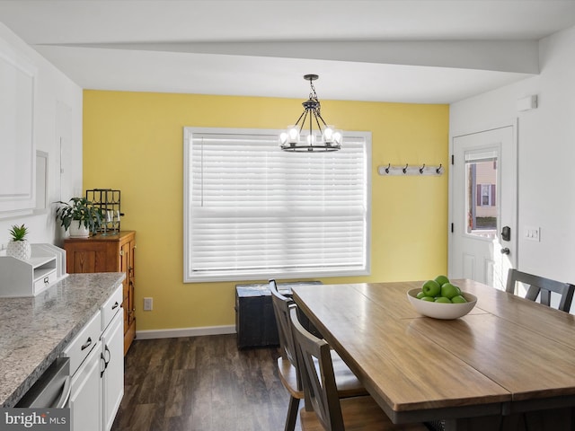 dining space featuring dark hardwood / wood-style flooring and a notable chandelier