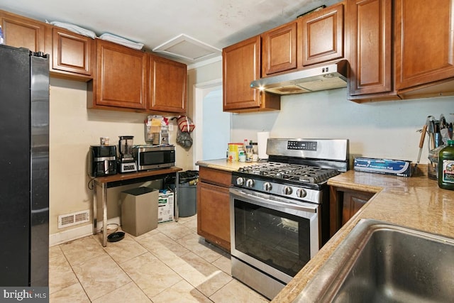 kitchen with appliances with stainless steel finishes and light tile patterned floors