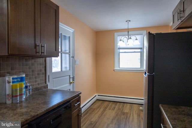 kitchen with dark brown cabinetry, black appliances, pendant lighting, decorative backsplash, and a baseboard heating unit