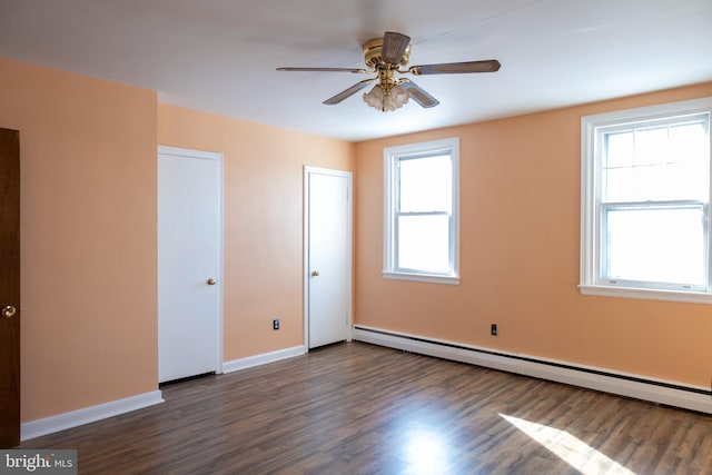 unfurnished bedroom featuring dark hardwood / wood-style flooring, a baseboard heating unit, and ceiling fan