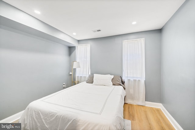 bedroom with hardwood / wood-style floors