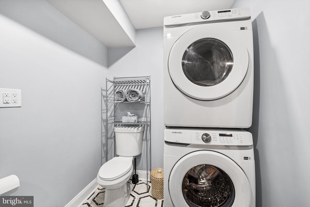 washroom featuring stacked washer / dryer