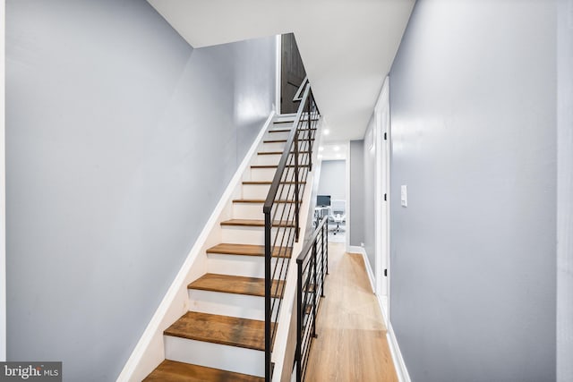 stairs with hardwood / wood-style floors