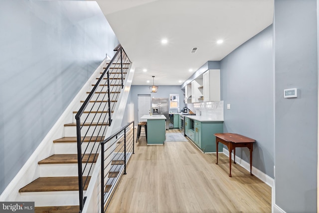 stairs with hardwood / wood-style floors