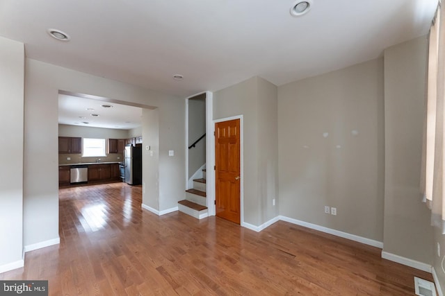 unfurnished room with hardwood / wood-style flooring and sink