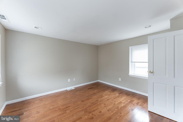 spare room featuring wood-type flooring