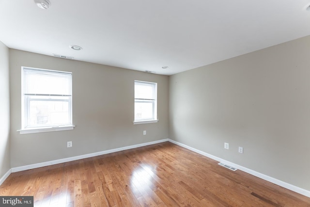 empty room with hardwood / wood-style flooring