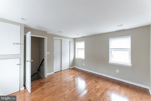 unfurnished bedroom featuring light hardwood / wood-style floors and a closet