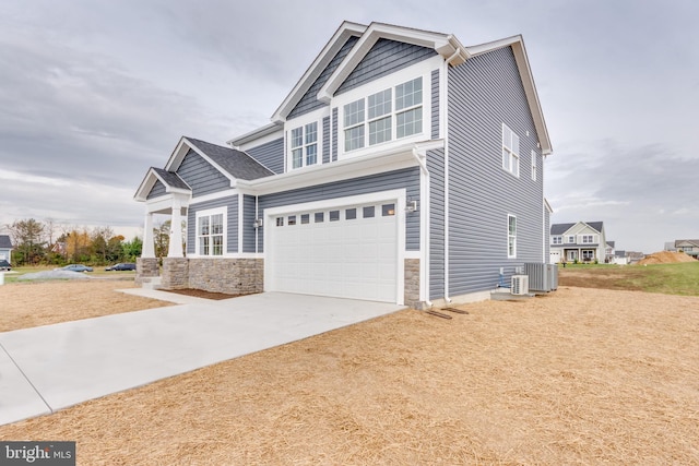 craftsman-style home featuring a garage and central AC unit