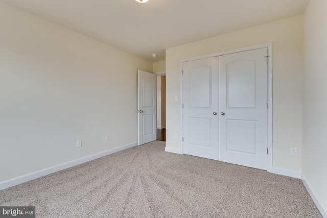 unfurnished bedroom featuring a closet and carpet