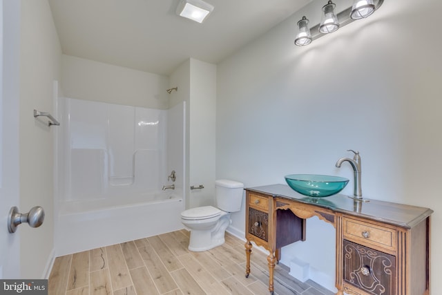 full bathroom featuring vanity, hardwood / wood-style flooring, shower / bathtub combination, and toilet