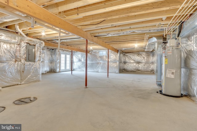 basement featuring electric panel and water heater