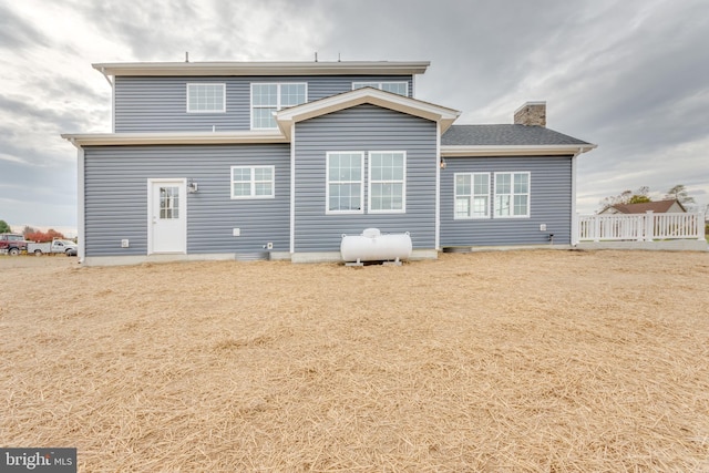 rear view of house featuring a lawn