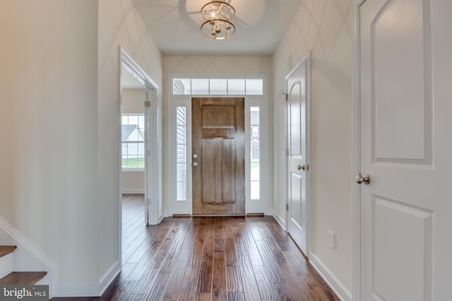 entryway featuring dark hardwood / wood-style flooring and a notable chandelier