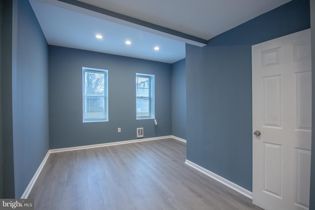 unfurnished room with wood-type flooring