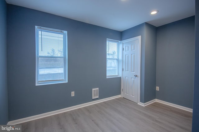 empty room with light hardwood / wood-style flooring