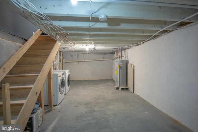 basement with water heater and washer and clothes dryer