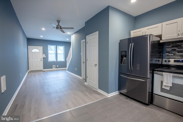 kitchen with white cabinetry, tasteful backsplash, light wood-type flooring, appliances with stainless steel finishes, and ceiling fan