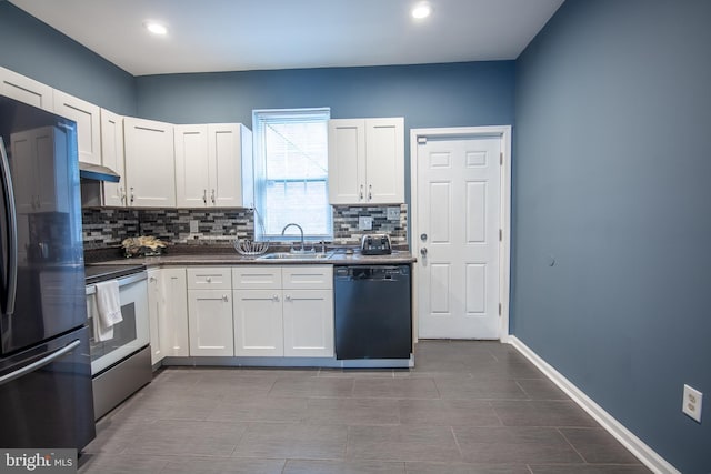 kitchen featuring white cabinets, sink, decorative backsplash, and black appliances