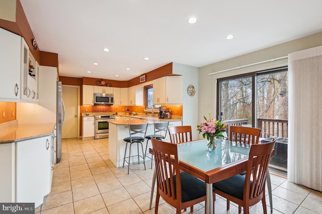 dining space featuring light tile patterned floors and recessed lighting