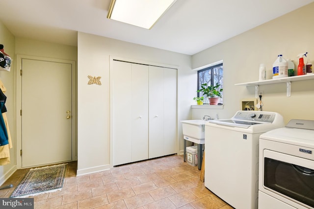 clothes washing area featuring washer and dryer and laundry area