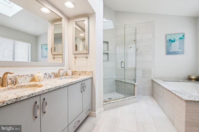 bathroom with a stall shower, a sink, a bath, and double vanity