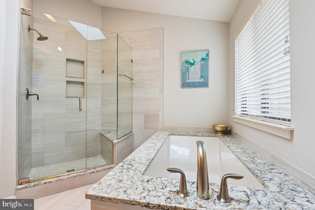 bathroom with lofted ceiling and a shower stall