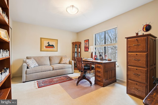 office featuring light carpet and baseboards