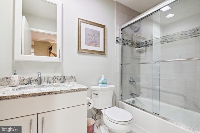 bathroom featuring shower / bath combination with glass door, vanity, and toilet