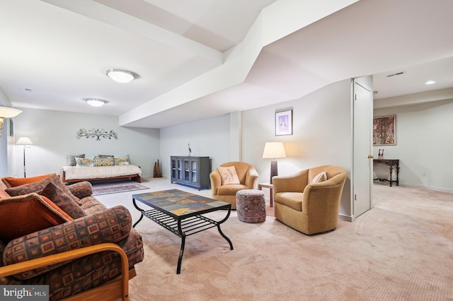 carpeted living area featuring visible vents and baseboards