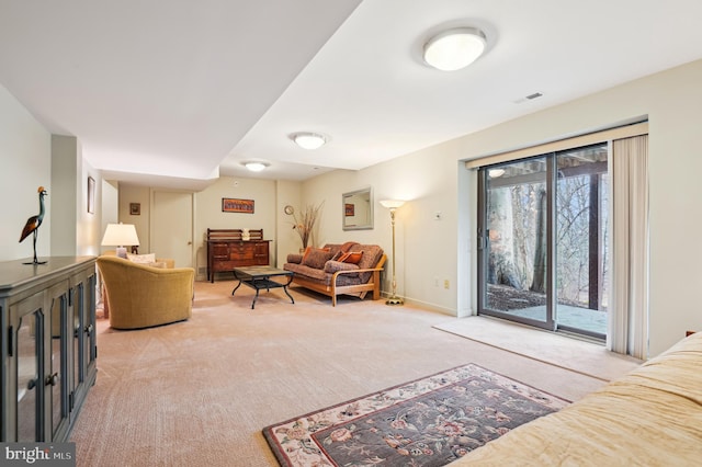 living room with light carpet, visible vents, and baseboards