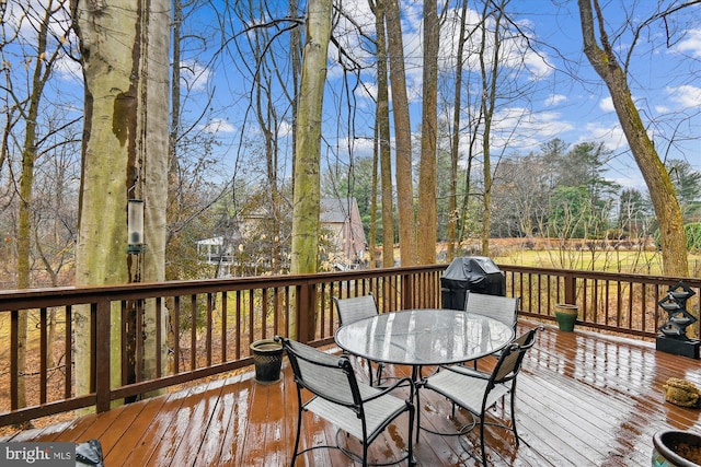 wooden deck featuring outdoor dining area and grilling area