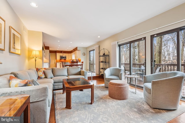 living area with wood finished floors and recessed lighting