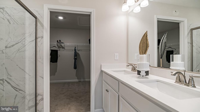 bathroom featuring vanity and a shower with door