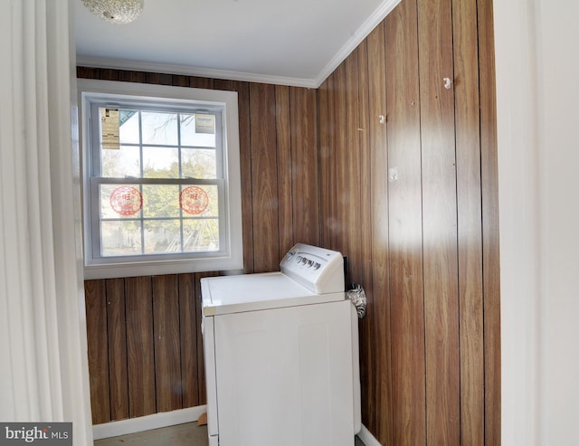 washroom featuring washer / dryer, ornamental molding, and wood walls