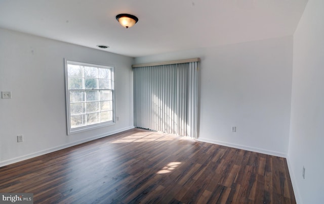 empty room with dark wood-type flooring