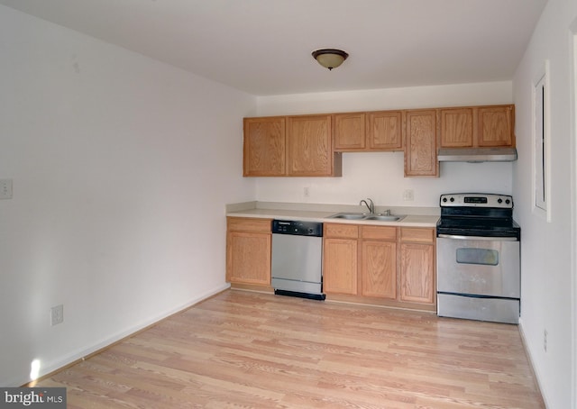 kitchen featuring stainless steel appliances, light brown cabinetry, sink, and light wood-type flooring