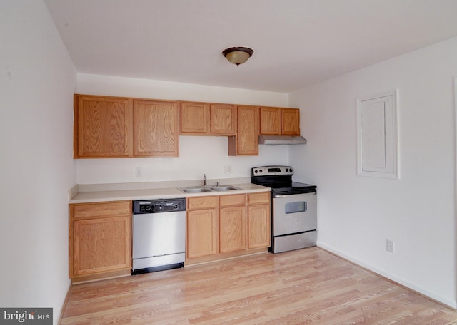 kitchen featuring stainless steel appliances, sink, light brown cabinets, and light wood-type flooring