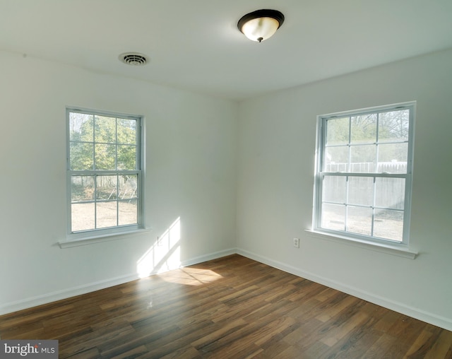 spare room with dark wood-type flooring