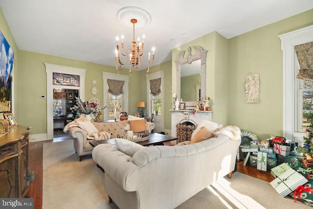 living room with a chandelier and light wood-type flooring