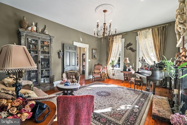 living room featuring an inviting chandelier and hardwood / wood-style floors