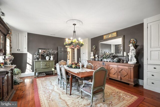 dining area with an inviting chandelier and hardwood / wood-style floors